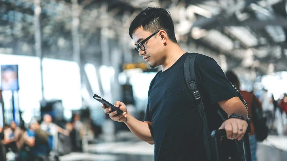 man-in-airport-on-phone-1200x675-gettyimages-1178814017.jpeg